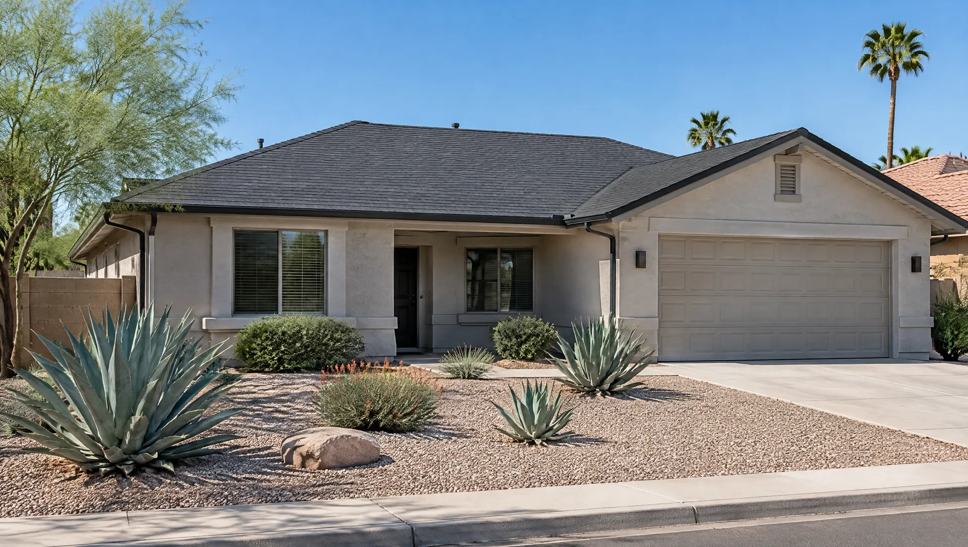 Single-story ranch home in Chandler with a new charcoal architectural asphalt shingle roof, straight shingle courses, new drip edge and gutters, gravel front yard with agave